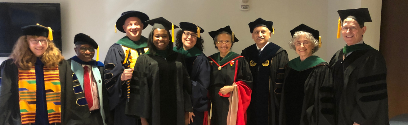 Physicians in academic robes at an award celebration